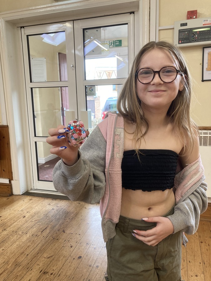 Holly holding her replica of a Faberge egg